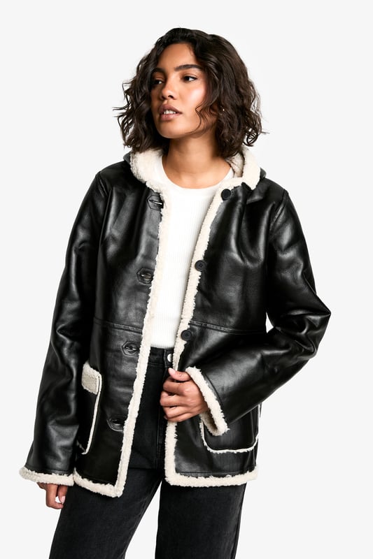 Hooded design for added warmth and style
        Cosy borg lining for superior insulation
        Contrasting trim detailing for a chic look
        Practical front pockets for convenience
        Versatile button-up front closure
    
    Make a bold statement this season with our Tall Kunstleder-Mantel mit Borg-Futter und Kapuze. This striking coat combines edgy style with practical comfort, perfect for the fashion-forward Boohoo girl. The contrasting borg lining not only adds a trendy touch but also ensures you stay snug during chilly days. Style it over a simple white tee and wide-leg trousers for a casual yet put-together look, as seen on our model. For a night out with friends, pair it with a mini dress and chunky boots to create an outfit that's sure to turn heads. The versatile nature of this coat makes it suitable for various casual occasions, from impromptu coffee dates to laid-back family gatherings. Its tall fit ensures a flattering silhouette for those blessed with height, while the practical hood and pockets add functionality to its fashionable design. Embrace the latest trends and stay cosy in style with this must-have piece from Boohoo.