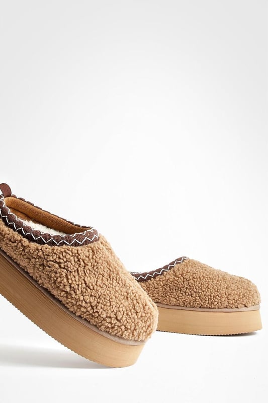 Cosy borg material for ultimate comfort
        Stylish platform design with a flat heel (0-2cm)
        Embroidered detailing adds a unique touch
        Slip-on style for easy wear
        Versatile mule silhouette for indoor and outdoor use
    
    Step into comfort and style with these eye-catching borg mules. The plush texture of the borg material envelops your feet in warmth, making them perfect for lounging at home or running quick errands. The platform design adds a trendy edge, while the flat heel ensures all-day comfort. The embroidered detailing elevates these mules from simple house shoes to a fashion statement. Pair them with your favourite joggers and an oversized jumper for a cosy day in, or style them with cropped jeans and a chunky knit for casual outings. These versatile slip-ons are ideal for family gatherings, lazy weekends, or any occasion where you want to combine comfort with a touch of flair. The easy slip-on style means you can quickly transition from indoor relaxation to outdoor adventures without missing a beat.