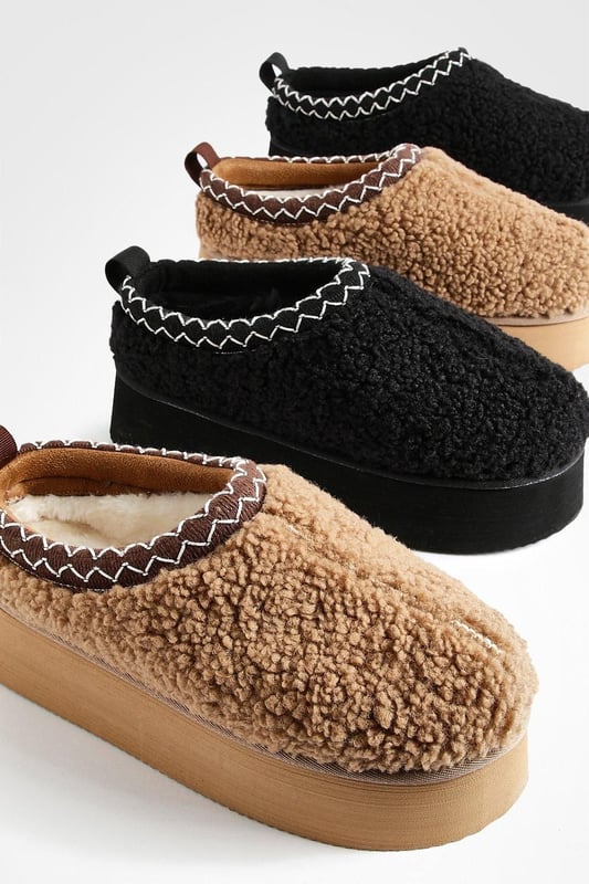Cosy borg material for ultimate comfort
        Stylish platform design with a flat heel (0-2cm)
        Embroidered detailing adds a unique touch
        Slip-on style for easy wear
        Versatile mule silhouette for indoor and outdoor use
    
    Step into comfort and style with these eye-catching borg mules. The plush texture of the borg material envelops your feet in warmth, making them perfect for lounging at home or running quick errands. The platform design adds a trendy edge, while the flat heel ensures all-day comfort. The embroidered detailing elevates these mules from simple house shoes to a fashion statement. Pair them with your favourite joggers and an oversized jumper for a cosy day in, or style them with cropped jeans and a chunky knit for casual outings. These versatile slip-ons are ideal for family gatherings, lazy weekends, or any occasion where you want to combine comfort with a touch of flair. The easy slip-on style means you can quickly transition from indoor relaxation to outdoor adventures without missing a beat.