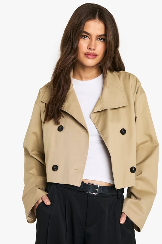 Chic cropped trench coat design
        Distinctive funnel collar for added style
        Double-breasted button fastening
        Wide, relaxed sleeves for a modern silhouette
        Versatile length perfect for layering
    
    This contemporary take on the classic trench coat is a must-have addition to your wardrobe. The cropped length and funnel collar create a fresh, youthful look that's perfect for the fashion-forward Boohoo girl. Style it with wide-leg trousers and a crisp white tee for a polished daytime ensemble. For a night out with the girls, throw it over a bodycon dress and pair with ankle boots. The relaxed fit allows for easy layering over jumpers when the temperature drops. Whether you're heading to uni, meeting friends for brunch, or enjoying a casual family gathering, this trench coat will keep you looking effortlessly stylish. Its versatility makes it an ideal choice for those impromptu plans that pop up in your busy social calendar.