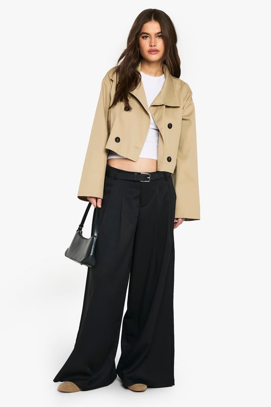 Chic cropped trench coat design
        Distinctive funnel collar for added style
        Double-breasted button fastening
        Wide, relaxed sleeves for a modern silhouette
        Versatile length perfect for layering
    
    This contemporary take on the classic trench coat is a must-have addition to your wardrobe. The cropped length and funnel collar create a fresh, youthful look that's perfect for the fashion-forward Boohoo girl. Style it with wide-leg trousers and a crisp white tee for a polished daytime ensemble. For a night out with the girls, throw it over a bodycon dress and pair with ankle boots. The relaxed fit allows for easy layering over jumpers when the temperature drops. Whether you're heading to uni, meeting friends for brunch, or enjoying a casual family gathering, this trench coat will keep you looking effortlessly stylish. Its versatility makes it an ideal choice for those impromptu plans that pop up in your busy social calendar.