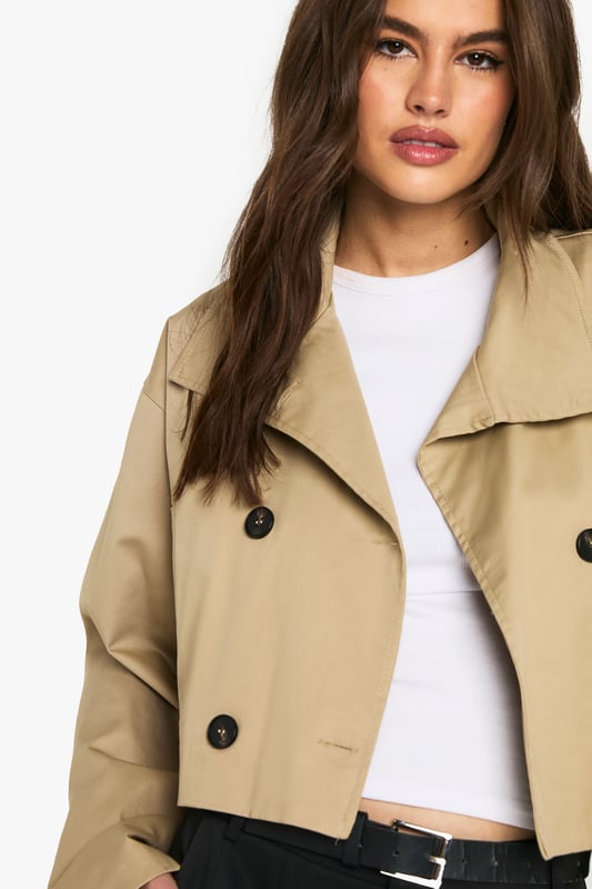 Chic cropped trench coat design
        Distinctive funnel collar for added style
        Double-breasted button fastening
        Wide, relaxed sleeves for a modern silhouette
        Versatile length perfect for layering
    
    This contemporary take on the classic trench coat is a must-have addition to your wardrobe. The cropped length and funnel collar create a fresh, youthful look that's perfect for the fashion-forward Boohoo girl. Style it with wide-leg trousers and a crisp white tee for a polished daytime ensemble. For a night out with the girls, throw it over a bodycon dress and pair with ankle boots. The relaxed fit allows for easy layering over jumpers when the temperature drops. Whether you're heading to uni, meeting friends for brunch, or enjoying a casual family gathering, this trench coat will keep you looking effortlessly stylish. Its versatility makes it an ideal choice for those impromptu plans that pop up in your busy social calendar.