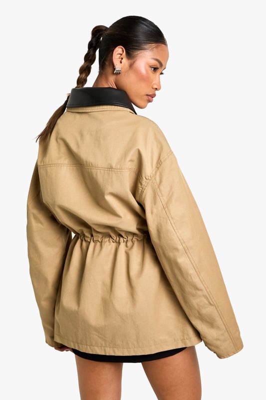 Striking contrast faux leather collar adds a contemporary edge to this utility-inspired jacket
        Practical front utility pockets perfect for keeping essentials close at hand
        Adjustable drawstring waist creates a flattering silhouette that can be cinched to preference
        Relaxed fit with dropped shoulders for effortless layering over jumpers and hoodies
        Button-through front closure with sturdy hardware details for added durability
    
    This versatile jacket with gathered waist detail combines practicality with on-trend style. The contrasting collar creates a distinctive look that works brilliantly for casual daytime outings. Style as seen with a simple black mini dress and knee-high boots for an effortlessly cool weekend ensemble, or pair with your favourite jeans and trainers for coffee dates and shopping trips. The adjustable waist allows you to customise the fit, creating either a more relaxed or defined silhouette depending on your mood. Perfect for unpredictable British weather, this jacket offers just the right amount of coverage for autumn strolls or spring evenings. The utility-inspired design makes it an ideal companion for family gatherings or casual meet-ups where comfort and style are equally important.