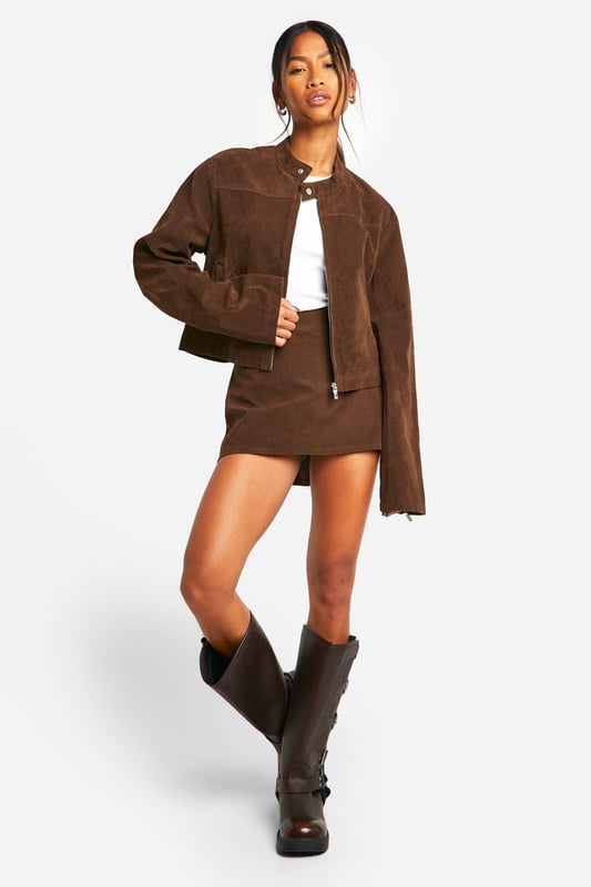 Faux suede jacket with zip-up front for easy wear
        Collarless design with a sleek, modern silhouette
        Long sleeves for versatile styling options
        Side pockets for practicality and hand warmth
        Cropped length perfect for pairing with high-waisted bottoms
    
    This faux suede jacket is a must-have addition to your casual wardrobe. Its soft texture and rich appearance lend a touch of luxury to any outfit, whilst maintaining a relaxed vibe. The zip-up front allows for effortless styling, whether fully fastened for a polished look or left open for a more laid-back feel. Pair it with a crisp white top and a matching mini skirt for a coordinated ensemble that's perfect for brunch with friends or a day of shopping. For a more casual approach, team it with your favourite jeans and trainers. The versatility of this jacket makes it ideal for family gatherings or casual outings. Its cropped length works wonderfully with high-waisted trousers or skirts, creating a balanced silhouette. Accessorise with statement earrings and a crossbody bag to complete your look. This Boohoo jacket embodies the brand's ethos of providing trendy, inclusive fashion that doesn't compromise on style or value.