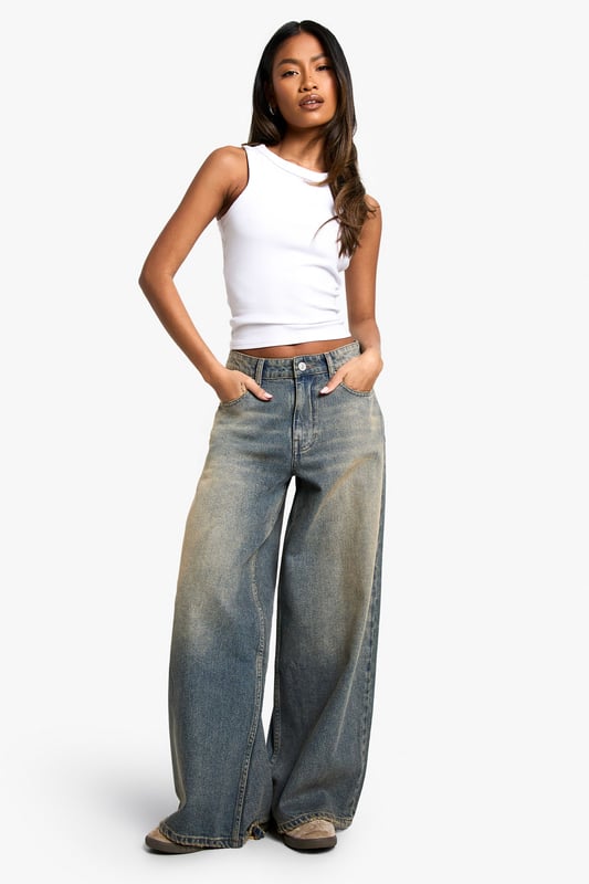 Wide leg silhouette for a relaxed, on-trend look
        Vintage wash effect adds character and depth
        Frayed hem detail for an edgy, lived-in vibe
        High-rise waist flatters the figure
        Classic five-pocket design for practicality
    
    Make a statement with these eye-catching wide-leg jeans from Boohoo. The vintage wash and frayed hem combine to create a perfectly worn-in look that's both trendy and timeless. Pair with a cropped white vest top for a casual daytime ensemble, or dress them up with a fitted bodysuit and heels for a night out. The high-rise waist and relaxed fit through the legs offer comfort and style in equal measure. For a layered look, throw on an oversized denim jacket or a chunky knit jumper. These versatile jeans are ideal for family gatherings, brunches with friends, or casual Fridays at the office. Their effortless cool factor makes them a wardrobe staple that you'll reach for time and time again.