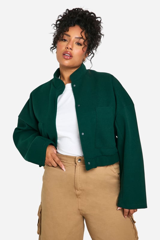 Cropped bomber jacket silhouette for a modern twist
        Distinctive seam detailing adds visual interest
        Stand-up collar for extra warmth and style
        Snap button closure for easy wear
        Relaxed fit allows for layering versatility
    
    Make a bold statement with this eye-catching plus size bomber jacket. The cropped length and distinctive seam detailing create a contemporary silhouette that's perfect for the fashion-forward woman. Layer it over a crisp white tee and pair with wide-leg trousers for a chic, casual ensemble that's ideal for weekend brunches or shopping trips with friends. The relaxed fit allows for easy movement, while the stand-up collar adds a touch of sophistication. For a night out, throw it over a sleek bodycon dress and add some statement earrings to elevate your look. This versatile piece effortlessly transitions from day to night, making it a must-have addition to your wardrobe. Whether you're heading to a casual gathering or a laid-back evening event, this bomber jacket will ensure you stand out from the crowd with its unique blend of comfort and style.