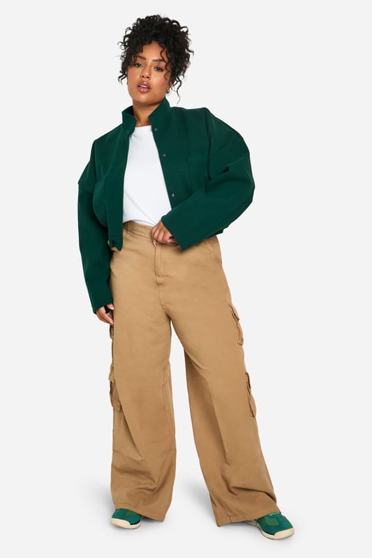 Cropped bomber jacket silhouette for a modern twist
        Distinctive seam detailing adds visual interest
        Stand-up collar for extra warmth and style
        Snap button closure for easy wear
        Relaxed fit allows for layering versatility
    
    Make a bold statement with this eye-catching plus size bomber jacket. The cropped length and distinctive seam detailing create a contemporary silhouette that's perfect for the fashion-forward woman. Layer it over a crisp white tee and pair with wide-leg trousers for a chic, casual ensemble that's ideal for weekend brunches or shopping trips with friends. The relaxed fit allows for easy movement, while the stand-up collar adds a touch of sophistication. For a night out, throw it over a sleek bodycon dress and add some statement earrings to elevate your look. This versatile piece effortlessly transitions from day to night, making it a must-have addition to your wardrobe. Whether you're heading to a casual gathering or a laid-back evening event, this bomber jacket will ensure you stand out from the crowd with its unique blend of comfort and style.