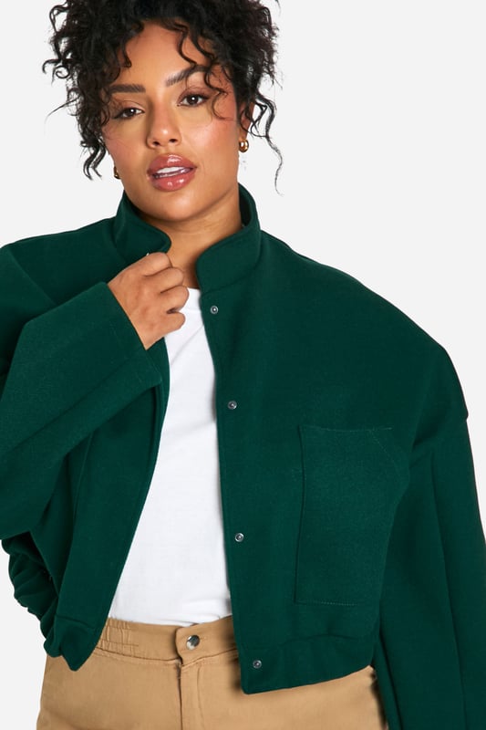Cropped bomber jacket silhouette for a modern twist
        Distinctive seam detailing adds visual interest
        Stand-up collar for extra warmth and style
        Snap button closure for easy wear
        Relaxed fit allows for layering versatility
    
    Make a bold statement with this eye-catching plus size bomber jacket. The cropped length and distinctive seam detailing create a contemporary silhouette that's perfect for the fashion-forward woman. Layer it over a crisp white tee and pair with wide-leg trousers for a chic, casual ensemble that's ideal for weekend brunches or shopping trips with friends. The relaxed fit allows for easy movement, while the stand-up collar adds a touch of sophistication. For a night out, throw it over a sleek bodycon dress and add some statement earrings to elevate your look. This versatile piece effortlessly transitions from day to night, making it a must-have addition to your wardrobe. Whether you're heading to a casual gathering or a laid-back evening event, this bomber jacket will ensure you stand out from the crowd with its unique blend of comfort and style.