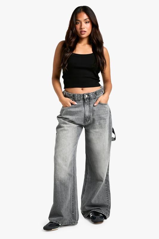 Wide-leg silhouette for a trendy, relaxed fit
        High-rise waist with belt loops for versatile styling
        Spacious side pockets and back pockets for practicality
        Durable cotton fabric for long-lasting wear
        Petite-friendly length, perfect for shorter frames
    
    Make a bold statement with these eye-catching wide-leg jeans from Boohoo's petite collection. Designed to flatter shorter frames, these trousers offer a perfect blend of comfort and style. The high-rise waist cinches you in at your smallest point, while the relaxed wide-leg cut creates a fashionable silhouette that's bang on trend. Style these versatile jeans with a cropped top and oversized jacket for a casual daytime look, or dress them up with a fitted bodysuit and heeled boots for a night out with friends. The durable cotton fabric ensures these jeans will be a wardrobe staple for seasons to come, making them ideal for everything from family gatherings to casual Fridays at the office. Embrace the latest fashion trends and showcase your unique style with these must-have petite jeans.