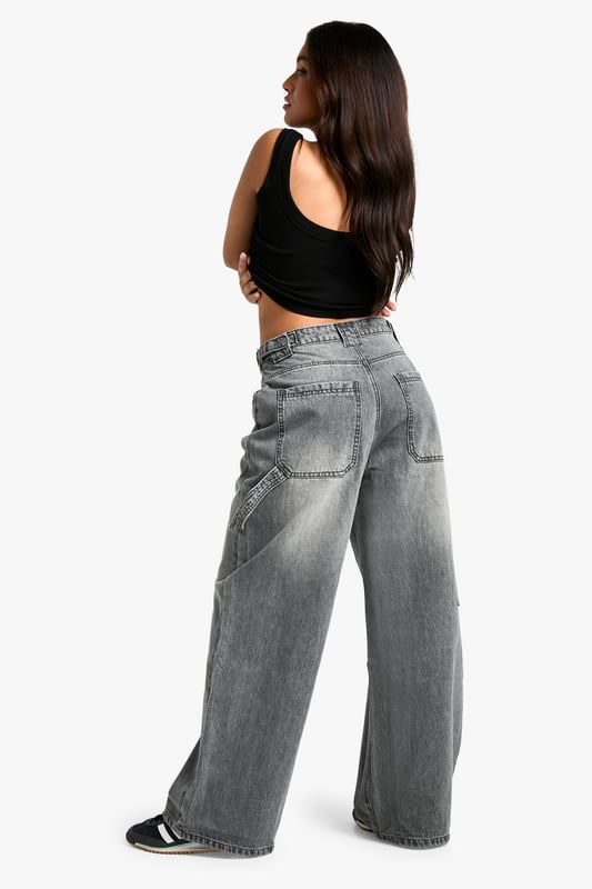 Wide-leg silhouette for a trendy, relaxed fit
        High-rise waist with belt loops for versatile styling
        Spacious side pockets and back pockets for practicality
        Durable cotton fabric for long-lasting wear
        Petite-friendly length, perfect for shorter frames
    
    Make a bold statement with these eye-catching wide-leg jeans from Boohoo's petite collection. Designed to flatter shorter frames, these trousers offer a perfect blend of comfort and style. The high-rise waist cinches you in at your smallest point, while the relaxed wide-leg cut creates a fashionable silhouette that's bang on trend. Style these versatile jeans with a cropped top and oversized jacket for a casual daytime look, or dress them up with a fitted bodysuit and heeled boots for a night out with friends. The durable cotton fabric ensures these jeans will be a wardrobe staple for seasons to come, making them ideal for everything from family gatherings to casual Fridays at the office. Embrace the latest fashion trends and showcase your unique style with these must-have petite jeans.