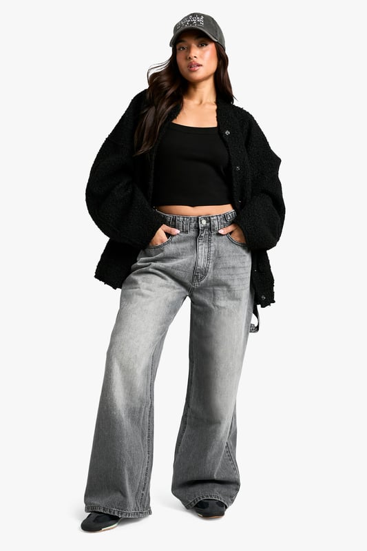 Wide-leg silhouette for a trendy, relaxed fit
        High-rise waist with belt loops for versatile styling
        Spacious side pockets and back pockets for practicality
        Durable cotton fabric for long-lasting wear
        Petite-friendly length, perfect for shorter frames
    
    Make a bold statement with these eye-catching wide-leg jeans from Boohoo's petite collection. Designed to flatter shorter frames, these trousers offer a perfect blend of comfort and style. The high-rise waist cinches you in at your smallest point, while the relaxed wide-leg cut creates a fashionable silhouette that's bang on trend. Style these versatile jeans with a cropped top and oversized jacket for a casual daytime look, or dress them up with a fitted bodysuit and heeled boots for a night out with friends. The durable cotton fabric ensures these jeans will be a wardrobe staple for seasons to come, making them ideal for everything from family gatherings to casual Fridays at the office. Embrace the latest fashion trends and showcase your unique style with these must-have petite jeans.
