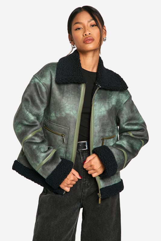 Vintage-inspired aviator jacket with a modern twist
        Cosy teddy lining for extra warmth and comfort
        Oversized fit for a relaxed, on-trend silhouette
        Asymmetrical zip closure for a unique edge
        Multiple pockets for practicality and style
    
    Embrace the cool-girl aesthetic with this striking aviator jacket. The vintage-inspired design is given a contemporary update with its oversized silhouette and asymmetrical zip closure. Perfect for those chilly autumn days, the teddy lining provides exceptional warmth without compromising on style. Pair it with wide-leg trousers and chunky trainers for an effortlessly chic daytime look. For evening outings, throw it over a little black dress and ankle boots to add an edgy contrast to your ensemble. Whether you're heading to a casual brunch or a night out with friends, this versatile piece will keep you looking fashionable and feeling cosy. The multiple pockets offer both practicality and style, making this jacket a must-have addition to your wardrobe that you'll reach for time and time again.