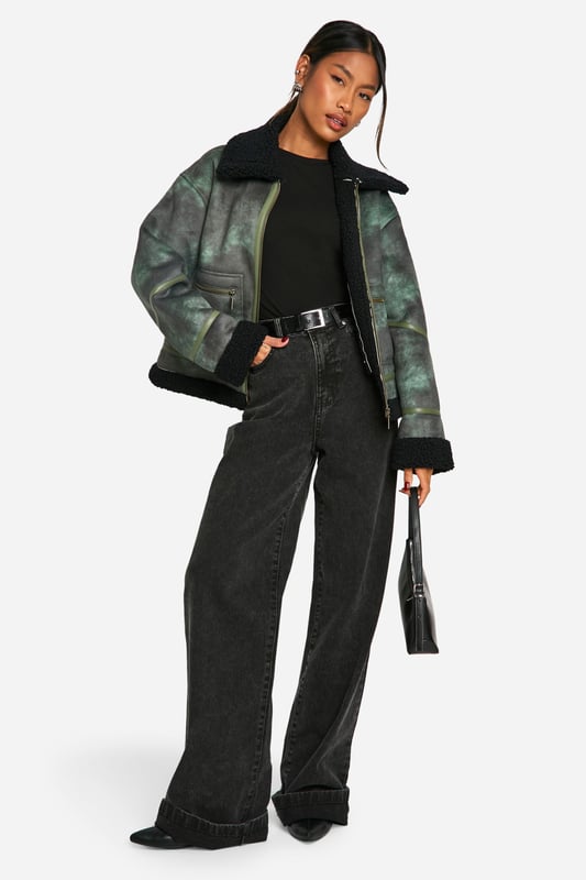 Vintage-inspired aviator jacket with a modern twist
        Cosy teddy lining for extra warmth and comfort
        Oversized fit for a relaxed, on-trend silhouette
        Asymmetrical zip closure for a unique edge
        Multiple pockets for practicality and style
    
    Embrace the cool-girl aesthetic with this striking aviator jacket. The vintage-inspired design is given a contemporary update with its oversized silhouette and asymmetrical zip closure. Perfect for those chilly autumn days, the teddy lining provides exceptional warmth without compromising on style. Pair it with wide-leg trousers and chunky trainers for an effortlessly chic daytime look. For evening outings, throw it over a little black dress and ankle boots to add an edgy contrast to your ensemble. Whether you're heading to a casual brunch or a night out with friends, this versatile piece will keep you looking fashionable and feeling cosy. The multiple pockets offer both practicality and style, making this jacket a must-have addition to your wardrobe that you'll reach for time and time again.
