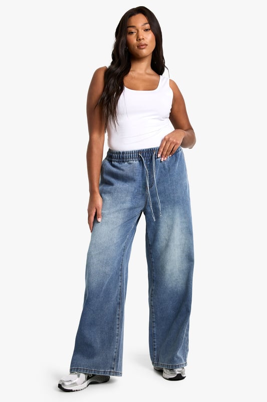 Straight-leg denim jeans with elastic waistband for comfort
        Wide-leg silhouette for a relaxed, on-trend look
        High-rise fit to flatter curves and provide coverage
        Adjustable drawstring for a customisable fit
        Versatile medium wash suitable for various casual occasions
    
    Embrace laid-back chic with these plus-size straight-leg jeans from Boohoo. The elastic waistband and adjustable drawstring offer unparalleled comfort and a personalised fit, perfect for all-day wear. The wide-leg silhouette creates a trendy, relaxed look that's ideal for casual outings. Style these jeans with a fitted white vest top and an oversized denim jacket for an effortlessly cool double denim ensemble. Add a pair of chunky trainers for a street-style edge, or dress them up with block-heel sandals for a casual night out. These versatile jeans are a wardrobe essential, easily transitioning from daytime errands to relaxed evening gatherings with friends. The high-rise fit and straight leg combine to create a flattering silhouette that complements curves beautifully, making these jeans a go-to choice for the fashion-forward woman who values both style and comfort.