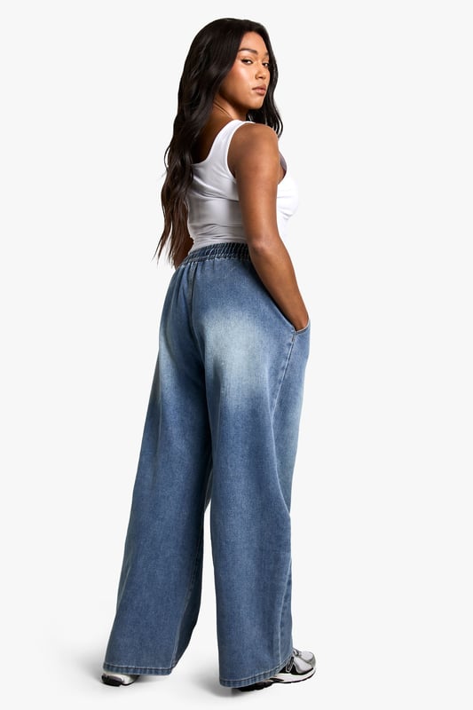 Straight-leg denim jeans with elastic waistband for comfort
        Wide-leg silhouette for a relaxed, on-trend look
        High-rise fit to flatter curves and provide coverage
        Adjustable drawstring for a customisable fit
        Versatile medium wash suitable for various casual occasions
    
    Embrace laid-back chic with these plus-size straight-leg jeans from Boohoo. The elastic waistband and adjustable drawstring offer unparalleled comfort and a personalised fit, perfect for all-day wear. The wide-leg silhouette creates a trendy, relaxed look that's ideal for casual outings. Style these jeans with a fitted white vest top and an oversized denim jacket for an effortlessly cool double denim ensemble. Add a pair of chunky trainers for a street-style edge, or dress them up with block-heel sandals for a casual night out. These versatile jeans are a wardrobe essential, easily transitioning from daytime errands to relaxed evening gatherings with friends. The high-rise fit and straight leg combine to create a flattering silhouette that complements curves beautifully, making these jeans a go-to choice for the fashion-forward woman who values both style and comfort.