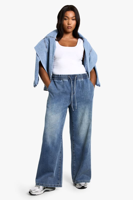 Straight-leg denim jeans with elastic waistband for comfort
        Wide-leg silhouette for a relaxed, on-trend look
        High-rise fit to flatter curves and provide coverage
        Adjustable drawstring for a customisable fit
        Versatile medium wash suitable for various casual occasions
    
    Embrace laid-back chic with these plus-size straight-leg jeans from Boohoo. The elastic waistband and adjustable drawstring offer unparalleled comfort and a personalised fit, perfect for all-day wear. The wide-leg silhouette creates a trendy, relaxed look that's ideal for casual outings. Style these jeans with a fitted white vest top and an oversized denim jacket for an effortlessly cool double denim ensemble. Add a pair of chunky trainers for a street-style edge, or dress them up with block-heel sandals for a casual night out. These versatile jeans are a wardrobe essential, easily transitioning from daytime errands to relaxed evening gatherings with friends. The high-rise fit and straight leg combine to create a flattering silhouette that complements curves beautifully, making these jeans a go-to choice for the fashion-forward woman who values both style and comfort.