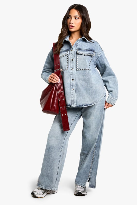 Oversized denim shirt featuring eye-catching stud detailing along the pockets
        Relaxed drop shoulder design for that effortlessly cool aesthetic
        Front button fastening with classic collar for versatile styling options
        Spacious chest pockets with distinctive stud embellishment
        Specially designed for petite frames whilst maintaining the trendy oversized silhouette
    
    This statement denim shirt combines casual comfort with edgy detailing, perfect for the fashion-forward woman who loves to make an impression. The oversized fit creates a relaxed silhouette that works brilliantly when paired with matching denim for a coordinated ensemble, as shown by our model. Layer over a simple vest top and team with wide-leg trousers for a contemporary daytime look, or half-tuck into high-waisted jeans for a more defined shape. The stud detailing adds a touch of attitude to casual gatherings and weekend brunches. For cooler days, style under an oversized blazer with trainers for an on-trend casual outfit, or dress up with ankle boots and statement jewellery for evening drinks. This versatile Boohoo piece transitions effortlessly from day to night whilst maintaining that coveted laid-back vibe.