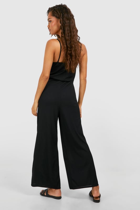 Ribbed texture for added visual interest
        Square neckline for a modern, flattering look
        Wide-leg culotte style for comfort and ease of movement
        Sleeveless design perfect for warmer weather
        Versatile one-piece outfit for effortless styling
    
    Embrace laid-back chic with this ribbed basic culotte jumpsuit from Boohoo. The square neckline adds a contemporary touch, while the wide-leg culotte style ensures both comfort and style. Perfect for casual outings, this jumpsuit can be dressed up or down with ease. Pair it with flat sandals and a woven tote for a relaxed daytime look, or add statement earrings and strappy heels for an evening out. The sleeveless design makes it ideal for warm weather, but it can also be layered with a lightweight cardigan or denim jacket for cooler days. Whether you're heading to a family gathering or meeting friends for brunch, this versatile jumpsuit is sure to become a go-to piece in your wardrobe.