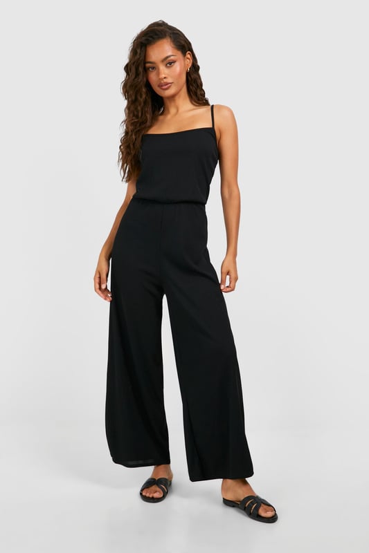 Ribbed texture for added visual interest
        Square neckline for a modern, flattering look
        Wide-leg culotte style for comfort and ease of movement
        Sleeveless design perfect for warmer weather
        Versatile one-piece outfit for effortless styling
    
    Embrace laid-back chic with this ribbed basic culotte jumpsuit from Boohoo. The square neckline adds a contemporary touch, while the wide-leg culotte style ensures both comfort and style. Perfect for casual outings, this jumpsuit can be dressed up or down with ease. Pair it with flat sandals and a woven tote for a relaxed daytime look, or add statement earrings and strappy heels for an evening out. The sleeveless design makes it ideal for warm weather, but it can also be layered with a lightweight cardigan or denim jacket for cooler days. Whether you're heading to a family gathering or meeting friends for brunch, this versatile jumpsuit is sure to become a go-to piece in your wardrobe.