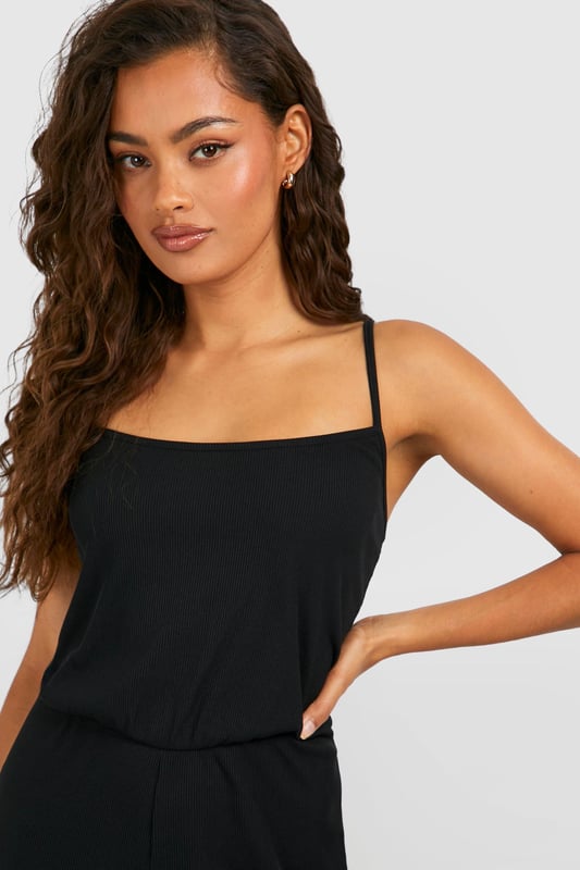 Ribbed texture for added visual interest
        Square neckline for a modern, flattering look
        Wide-leg culotte style for comfort and ease of movement
        Sleeveless design perfect for warmer weather
        Versatile one-piece outfit for effortless styling
    
    Embrace laid-back chic with this ribbed basic culotte jumpsuit from Boohoo. The square neckline adds a contemporary touch, while the wide-leg culotte style ensures both comfort and style. Perfect for casual outings, this jumpsuit can be dressed up or down with ease. Pair it with flat sandals and a woven tote for a relaxed daytime look, or add statement earrings and strappy heels for an evening out. The sleeveless design makes it ideal for warm weather, but it can also be layered with a lightweight cardigan or denim jacket for cooler days. Whether you're heading to a family gathering or meeting friends for brunch, this versatile jumpsuit is sure to become a go-to piece in your wardrobe.