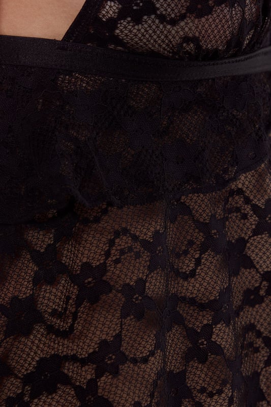 Delicate lace bralette featuring charming heart pattern detailing throughout
        Feminine ruffle trim adds playful movement and texture
        Adjustable thin straps for a customised fit
        Matching panty with coordinating heart lace design
        Subtle front bow detail connects the bralette's open front design
    
    This enchanting Nasty Gal lingerie set combines romantic aesthetics with contemporary design. The bralette showcases an alluring open front silhouette with a delicate bow connection, while the ruffle detailing adds a touch of flirtatious charm. The sheer lace construction reveals just enough whilst the heart pattern throughout adds a romantic motif that's both subtle and striking. The matching panty completes the coordinated look with the same intricate lace pattern. Perfect for special occasions or whenever you wish to feel particularly confident, this set strikes the ideal balance between comfort and allure. The adjustable straps ensure you can achieve your perfect fit, making this set as practical as it is beautiful.