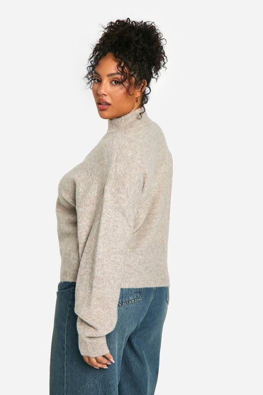 Soft, cosy high neck design for ultimate comfort
        Relaxed fit with dropped shoulders for effortless style
        Ribbed cuffs and hem for a snug, secure fit
        Versatile neutral tone suitable for various outfits
        Plus size friendly, ensuring a flattering fit for all body types
    
    Embrace laid-back luxury with this plus-size high neck jumper from Boohoo. Perfect for those chilly days when you want to feel wrapped in warmth without compromising on style. The relaxed silhouette with its dropped shoulders offers a contemporary edge, while the soft fabric ensures all-day comfort. Pair it with wide-leg jeans and trainers for a casual weekend look, or dress it up with a midi skirt and ankle boots for a cosy yet chic ensemble. This jumper is ideal for family gatherings, coffee dates with friends, or simply lounging at home. Its versatility makes it a wardrobe staple that you'll reach for time and time again. The ribbed detailing at the cuffs and hem adds a touch of refinement, ensuring the jumper maintains its shape wear after wear. Whether you're running errands or meeting friends for a casual lunch, this high neck jumper is your go-to for effortless style and comfort.