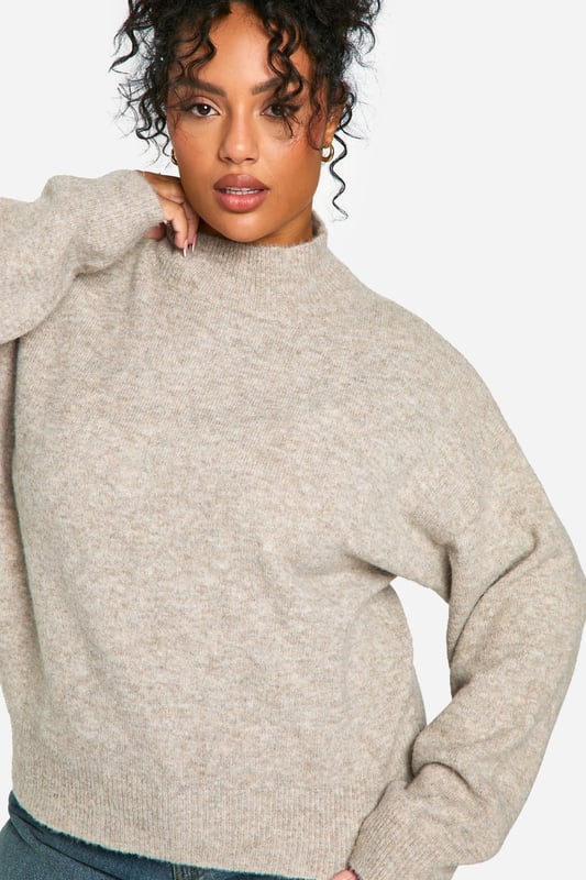 Soft, cosy high neck design for ultimate comfort
        Relaxed fit with dropped shoulders for effortless style
        Ribbed cuffs and hem for a snug, secure fit
        Versatile neutral tone suitable for various outfits
        Plus size friendly, ensuring a flattering fit for all body types
    
    Embrace laid-back luxury with this plus-size high neck jumper from Boohoo. Perfect for those chilly days when you want to feel wrapped in warmth without compromising on style. The relaxed silhouette with its dropped shoulders offers a contemporary edge, while the soft fabric ensures all-day comfort. Pair it with wide-leg jeans and trainers for a casual weekend look, or dress it up with a midi skirt and ankle boots for a cosy yet chic ensemble. This jumper is ideal for family gatherings, coffee dates with friends, or simply lounging at home. Its versatility makes it a wardrobe staple that you'll reach for time and time again. The ribbed detailing at the cuffs and hem adds a touch of refinement, ensuring the jumper maintains its shape wear after wear. Whether you're running errands or meeting friends for a casual lunch, this high neck jumper is your go-to for effortless style and comfort.