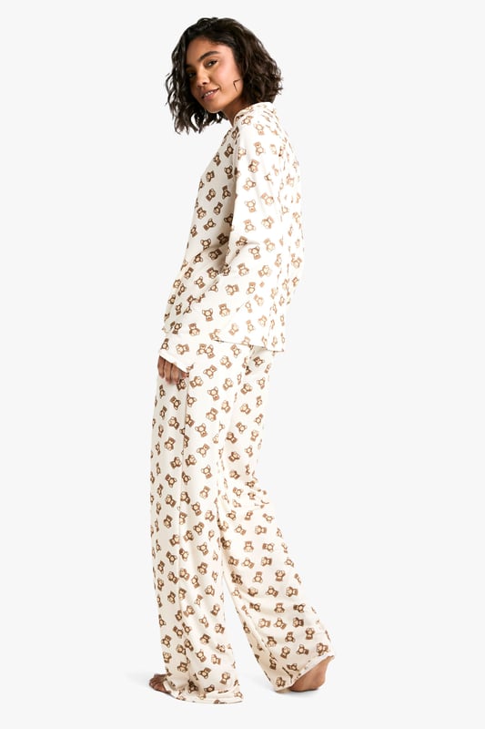 Charming bear print pyjama set
        Long-sleeved button-up top with notched collar
        Matching full-length trousers
        Soft jersey fabric for ultimate comfort
        Designed for tall frames
    
    Drift off to dreamland in style with this adorable bear print pyjama set from Boohoo. Perfect for those cosy nights in, this set combines comfort and charm effortlessly. The long-sleeved top features a classic button-up front and notched collar, while the full-length trousers ensure you stay snug from top to toe. Crafted from soft jersey fabric, it's designed to keep you comfortable throughout the night. The playful bear print adds a touch of whimsy to your nighttime routine, making bedtime something to look forward to. Ideal for lounging, late-night Netflix binges, or lazy weekend mornings, this pyjama set is versatile enough for year-round wear. For a complete nighttime ensemble, pair with fluffy slippers and a warm dressing gown for those chilly evenings. Whether you're treating yourself or looking for the perfect gift, this pyjama set is sure to delight any fashion-forward sleepyhead.