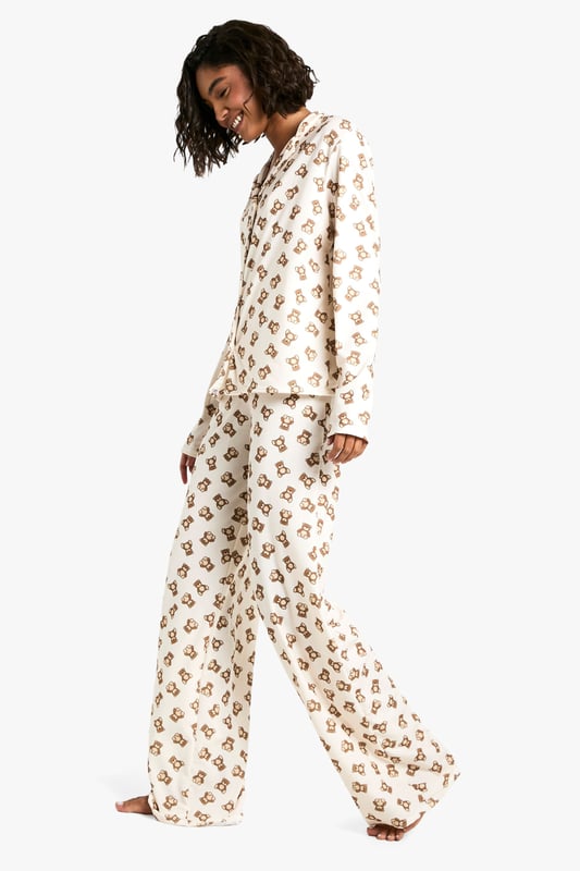 Charming bear print pyjama set
        Long-sleeved button-up top with notched collar
        Matching full-length trousers
        Soft jersey fabric for ultimate comfort
        Designed for tall frames
    
    Drift off to dreamland in style with this adorable bear print pyjama set from Boohoo. Perfect for those cosy nights in, this set combines comfort and charm effortlessly. The long-sleeved top features a classic button-up front and notched collar, while the full-length trousers ensure you stay snug from top to toe. Crafted from soft jersey fabric, it's designed to keep you comfortable throughout the night. The playful bear print adds a touch of whimsy to your nighttime routine, making bedtime something to look forward to. Ideal for lounging, late-night Netflix binges, or lazy weekend mornings, this pyjama set is versatile enough for year-round wear. For a complete nighttime ensemble, pair with fluffy slippers and a warm dressing gown for those chilly evenings. Whether you're treating yourself or looking for the perfect gift, this pyjama set is sure to delight any fashion-forward sleepyhead.