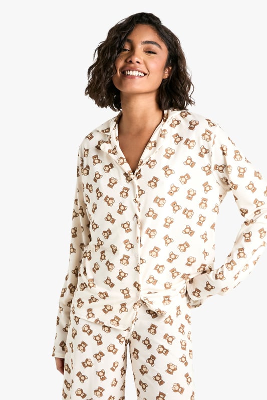 Charming bear print pyjama set
        Long-sleeved button-up top with notched collar
        Matching full-length trousers
        Soft jersey fabric for ultimate comfort
        Designed for tall frames
    
    Drift off to dreamland in style with this adorable bear print pyjama set from Boohoo. Perfect for those cosy nights in, this set combines comfort and charm effortlessly. The long-sleeved top features a classic button-up front and notched collar, while the full-length trousers ensure you stay snug from top to toe. Crafted from soft jersey fabric, it's designed to keep you comfortable throughout the night. The playful bear print adds a touch of whimsy to your nighttime routine, making bedtime something to look forward to. Ideal for lounging, late-night Netflix binges, or lazy weekend mornings, this pyjama set is versatile enough for year-round wear. For a complete nighttime ensemble, pair with fluffy slippers and a warm dressing gown for those chilly evenings. Whether you're treating yourself or looking for the perfect gift, this pyjama set is sure to delight any fashion-forward sleepyhead.