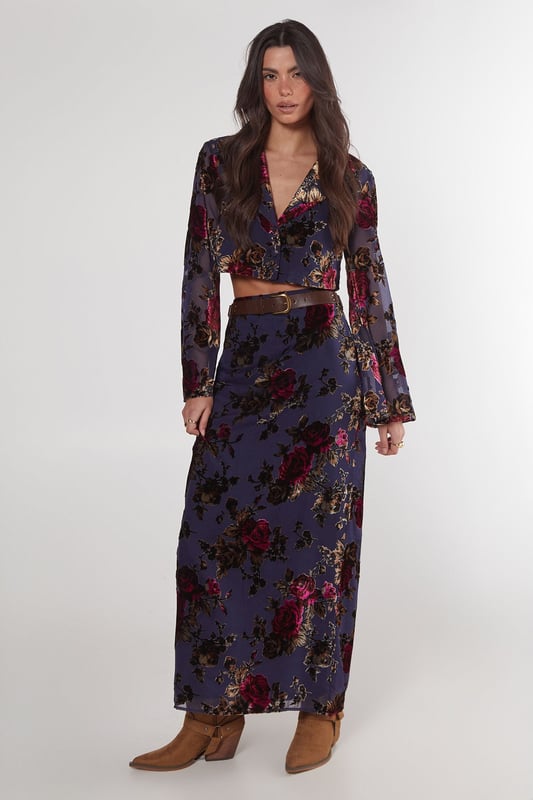 Striking floral devore pattern
        Maxi length for dramatic flair
        High-waisted design
        Side slit for ease of movement
        Coordinating crop top with bell sleeves
    
    Make a statement in this eye-catching floral devore maxi skirt from Nasty Gal. The intricate pattern adds depth and texture, while the maxi length creates a graceful silhouette. Perfect for daytime events, this skirt can be styled for various casual occasions. Pair it with the matching crop top as shown for a coordinated look, or mix it up with a plain fitted tee for a more relaxed vibe. The high-waisted design flatters the figure, while the side slit allows for comfortable movement. Complete the ensemble with ankle boots for a festival-ready outfit, or opt for flat sandals for a laid-back garden party. This versatile piece transitions effortlessly from family gatherings to casual brunches with friends, embodying the perfect blend of boho chic and contemporary style.