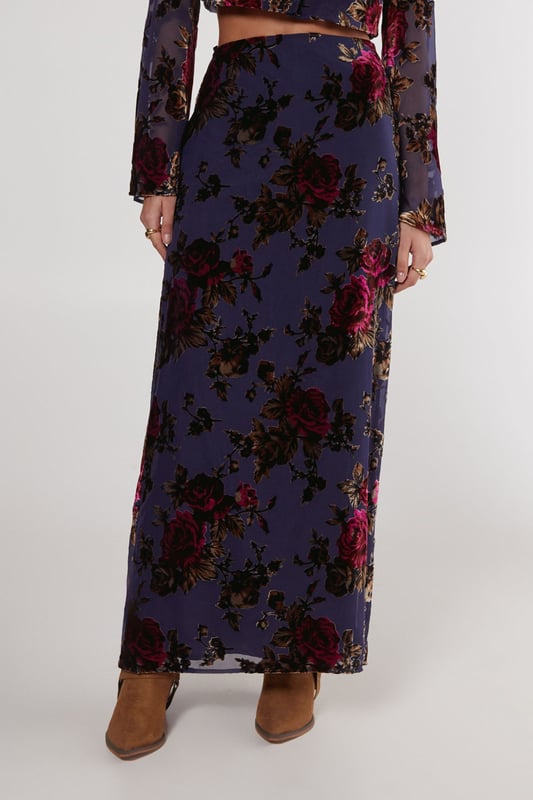 Striking floral devore pattern
        Maxi length for dramatic flair
        High-waisted design
        Side slit for ease of movement
        Coordinating crop top with bell sleeves
    
    Make a statement in this eye-catching floral devore maxi skirt from Nasty Gal. The intricate pattern adds depth and texture, while the maxi length creates a graceful silhouette. Perfect for daytime events, this skirt can be styled for various casual occasions. Pair it with the matching crop top as shown for a coordinated look, or mix it up with a plain fitted tee for a more relaxed vibe. The high-waisted design flatters the figure, while the side slit allows for comfortable movement. Complete the ensemble with ankle boots for a festival-ready outfit, or opt for flat sandals for a laid-back garden party. This versatile piece transitions effortlessly from family gatherings to casual brunches with friends, embodying the perfect blend of boho chic and contemporary style.