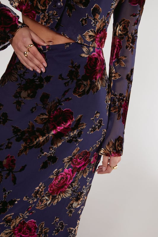 Striking floral devore pattern
        Maxi length for dramatic flair
        High-waisted design
        Side slit for ease of movement
        Coordinating crop top with bell sleeves
    
    Make a statement in this eye-catching floral devore maxi skirt from Nasty Gal. The intricate pattern adds depth and texture, while the maxi length creates a graceful silhouette. Perfect for daytime events, this skirt can be styled for various casual occasions. Pair it with the matching crop top as shown for a coordinated look, or mix it up with a plain fitted tee for a more relaxed vibe. The high-waisted design flatters the figure, while the side slit allows for comfortable movement. Complete the ensemble with ankle boots for a festival-ready outfit, or opt for flat sandals for a laid-back garden party. This versatile piece transitions effortlessly from family gatherings to casual brunches with friends, embodying the perfect blend of boho chic and contemporary style.