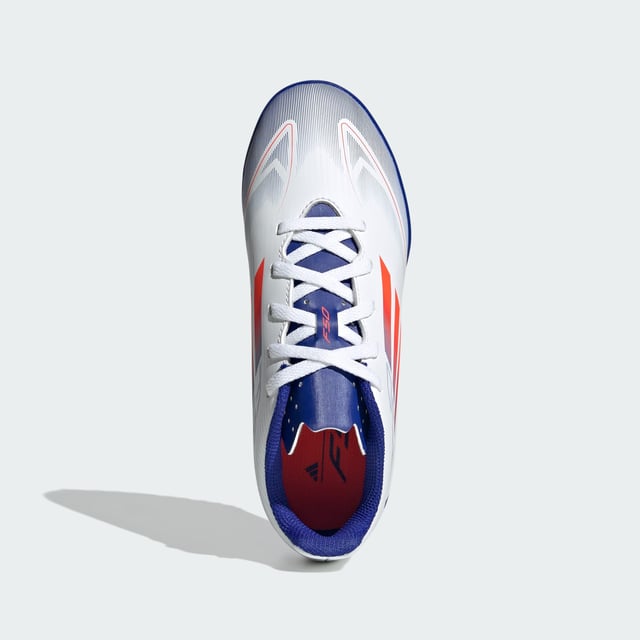 Free the fast with the adidas F50. Created to unlock the full potential of your acceleration, movement and speed. These juniors' adidas Club soccer cleats keep you comfortable with a textured synthetic upper and perforated tongue. Underneath, a lug rubber outsole ensures you stay ahead of the competition on artificial turf courts.  - Regular fit - Lace closure - Textured synthetic upper - Textile lining - Breathable perforated tongue - Rubber outsole for artificial turf  Shipped by adidas