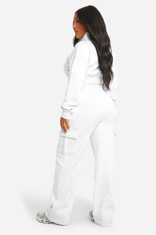 Cosy fleece-back fabric for ultimate comfort
        Cropped sweatshirt with ribbed collar and cuffs
        Straight-leg trousers with wrap-style waistband
        Convenient side pockets on trousers
        Versatile two-piece set for effortless styling
    
    Embrace laid-back chic with this Plus Sweatshirt and Straight Leg Trouser set from Boohoo. The cropped sweatshirt offers a trendy silhouette, while the straight-leg trousers with a unique wrap-style waistband add a contemporary twist to your casual wardrobe. Perfect for those lazy Sundays or running errands in style, this set is a must-have for the fashion-forward woman who values both comfort and trend-setting looks. Style it with chunky trainers and a crossbody bag for a cool, off-duty vibe, or dress it up with statement jewellery and sleek boots for a casual night out with friends. The versatility of this set makes it an ideal choice for various casual occasions, from family gatherings to weekend brunches, ensuring you look effortlessly stylish without compromising on comfort.