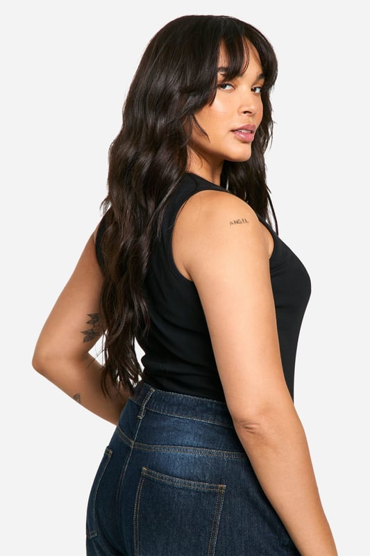 Ribbed jersey fabric for a comfortable, body-hugging fit
        Wide straps offer ample support and coverage
        Scoop neckline adds a feminine touch
        Versatile design suitable for layering or wearing alone
        Figure-flattering silhouette enhances curves
    
    This plus-size ribbed tank top from Boohoo is a wardrobe essential that combines style with comfort. The wide straps and scoop neckline create a flattering silhouette, while the ribbed jersey fabric ensures a snug fit that moves with you. Perfect for casual outings, this versatile piece can be styled in numerous ways. Pair it with high-waisted jeans and trainers for a relaxed daytime look, or dress it up with a midi skirt and statement jewellery for evening drinks with friends. Layer it under a blazer for a smart-casual office ensemble, or throw on a cardigan for family gatherings. The tank's adaptability makes it ideal for mixing and matching with various bottoms and accessories, allowing you to create multiple outfits for different occasions. Embrace your curves and feel confident in this chic, body-positive staple that's designed to complement your figure.