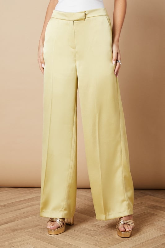 Luxurious satin fabric for a smooth, elegant finish
        Wide leg silhouette for a dramatic, flowing look
        High-waisted design with a tailored fit
        Side pockets for practicality and style
        Floor-skimming length for a sophisticated appearance
    
    Make a statement at your next formal event with these stunning wide leg tailored trousers from Oasis. The satin fabric lends a luxurious sheen that catches the light beautifully as you move, whilst the wide leg cut creates a striking silhouette that's both comfortable and chic. Perfect for weddings, races, or any occasion that calls for elegance, these trousers can be styled in numerous ways. For a coordinated look, pair with the matching blazer as shown, or create contrast with a fitted blouse. The high-waisted design elongates your legs, especially when worn with heels. Accessorise with delicate jewellery to complement the trousers' refined aesthetic. These versatile trousers transition effortlessly from day to night, making them a valuable addition to your occasion wear wardrobe.