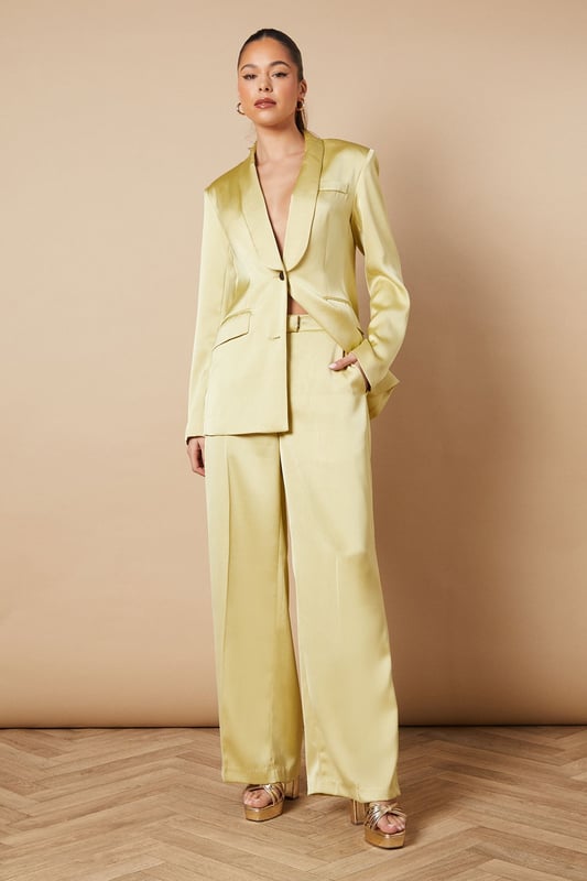 Luxurious satin fabric for a smooth, elegant finish
        Wide leg silhouette for a dramatic, flowing look
        High-waisted design with a tailored fit
        Side pockets for practicality and style
        Floor-skimming length for a sophisticated appearance
    
    Make a statement at your next formal event with these stunning wide leg tailored trousers from Oasis. The satin fabric lends a luxurious sheen that catches the light beautifully as you move, whilst the wide leg cut creates a striking silhouette that's both comfortable and chic. Perfect for weddings, races, or any occasion that calls for elegance, these trousers can be styled in numerous ways. For a coordinated look, pair with the matching blazer as shown, or create contrast with a fitted blouse. The high-waisted design elongates your legs, especially when worn with heels. Accessorise with delicate jewellery to complement the trousers' refined aesthetic. These versatile trousers transition effortlessly from day to night, making them a valuable addition to your occasion wear wardrobe.