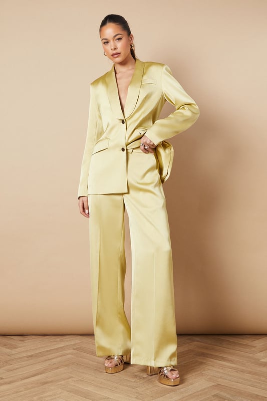 Luxurious satin fabric for a smooth, elegant finish
        Wide leg silhouette for a dramatic, flowing look
        High-waisted design with a tailored fit
        Side pockets for practicality and style
        Floor-skimming length for a sophisticated appearance
    
    Make a statement at your next formal event with these stunning wide leg tailored trousers from Oasis. The satin fabric lends a luxurious sheen that catches the light beautifully as you move, whilst the wide leg cut creates a striking silhouette that's both comfortable and chic. Perfect for weddings, races, or any occasion that calls for elegance, these trousers can be styled in numerous ways. For a coordinated look, pair with the matching blazer as shown, or create contrast with a fitted blouse. The high-waisted design elongates your legs, especially when worn with heels. Accessorise with delicate jewellery to complement the trousers' refined aesthetic. These versatile trousers transition effortlessly from day to night, making them a valuable addition to your occasion wear wardrobe.