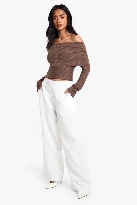 Straight leg trousers with distinctive waistband detail for a flattering silhouette
        Wide-leg design offering effortless movement and contemporary style
        Practical side pockets for convenience and functionality
        Smooth woven fabric with slight stretch for all-day comfort
        High-rise fit that pairs perfectly with cropped tops for night-out styling
    
    These statement trousers showcase a sophisticated waistband detail that creates a polished, put-together look for your evening adventures. The straight, wide-leg cut creates a dramatic silhouette that flows beautifully as you move, making them ideal for dancing the night away. Style with an off-shoulder top as shown for a balanced proportion that highlights the waistband feature. For a complete going-out ensemble, add pointed heels and a clutch bag for a look that transitions seamlessly from dinner to drinks. These versatile trousers work brilliantly for bar-hopping with friends or more upscale evening venues - simply adjust your accessories to suit the occasion. The clean lines and contemporary shape make these a wardrobe essential that will carry you through countless nights out with effortless style.