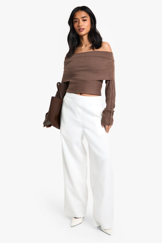 Straight leg trousers with distinctive waistband detail for a flattering silhouette
        Wide-leg design offering effortless movement and contemporary style
        Practical side pockets for convenience and functionality
        Smooth woven fabric with slight stretch for all-day comfort
        High-rise fit that pairs perfectly with cropped tops for night-out styling
    
    These statement trousers showcase a sophisticated waistband detail that creates a polished, put-together look for your evening adventures. The straight, wide-leg cut creates a dramatic silhouette that flows beautifully as you move, making them ideal for dancing the night away. Style with an off-shoulder top as shown for a balanced proportion that highlights the waistband feature. For a complete going-out ensemble, add pointed heels and a clutch bag for a look that transitions seamlessly from dinner to drinks. These versatile trousers work brilliantly for bar-hopping with friends or more upscale evening venues - simply adjust your accessories to suit the occasion. The clean lines and contemporary shape make these a wardrobe essential that will carry you through countless nights out with effortless style.