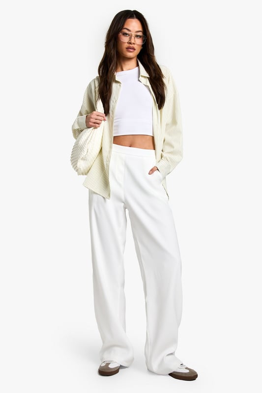 Designed specifically for taller frames with a flattering straight-leg silhouette
        Sleek waistband detail for a smooth, comfortable fit
        Practical side pockets for everyday essentials
        Versatile woven fabric with slight stretch for all-day comfort
        Wide-leg design creates a contemporary, fashion-forward look
    
    These sophisticated straight-leg trousers are the ultimate wardrobe essential for the fashion-forward woman. The clean lines and contemporary silhouette make them perfect for transitioning from day to night with effortless style. As seen on our model, pair with a simple crop top for a balanced look that showcases the high-waisted design, or add a structured blazer for more formal settings. The wide-leg cut creates a striking silhouette that works brilliantly with both trainers for casual daytime outings and heels for evening affairs. These trousers truly shine for going out occasions - whether you're heading to a trendy bar with friends or dancing the night away at a club. The slight stretch in the fabric ensures you'll remain comfortable whilst looking utterly chic throughout your evening adventures.