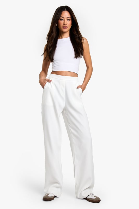 Designed specifically for taller frames with a flattering straight-leg silhouette
        Sleek waistband detail for a smooth, comfortable fit
        Practical side pockets for everyday essentials
        Versatile woven fabric with slight stretch for all-day comfort
        Wide-leg design creates a contemporary, fashion-forward look
    
    These sophisticated straight-leg trousers are the ultimate wardrobe essential for the fashion-forward woman. The clean lines and contemporary silhouette make them perfect for transitioning from day to night with effortless style. As seen on our model, pair with a simple crop top for a balanced look that showcases the high-waisted design, or add a structured blazer for more formal settings. The wide-leg cut creates a striking silhouette that works brilliantly with both trainers for casual daytime outings and heels for evening affairs. These trousers truly shine for going out occasions - whether you're heading to a trendy bar with friends or dancing the night away at a club. The slight stretch in the fabric ensures you'll remain comfortable whilst looking utterly chic throughout your evening adventures.