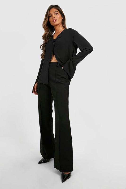 Flared leg design for a dramatic silhouette
        High-waisted fit accentuates the waistline
        Tailored construction for a polished look
        Stretchy bi-stretch fabric for comfort and movement
        Versatile style suitable for various occasions
    
    Make a statement with these eye-catching fit & flare tailored trousers from Boohoo. Perfect for the fashion-forward woman who loves to stand out, these trousers combine sophistication with a touch of drama. The high-waisted design elongates your legs, while the flared silhouette adds a bold, retro-inspired flair to your ensemble. Pair them with a cropped blazer and pointed-toe heels for a chic night out look, or dress them down with a fitted turtleneck and ankle boots for a stylish daytime outfit. The bi-stretch fabric ensures all-day comfort, allowing you to move with ease whether you're dancing the night away or navigating a busy day in the city. These trousers are a versatile addition to your wardrobe, easily transitioning from office to evening drinks with a simple change of accessories.