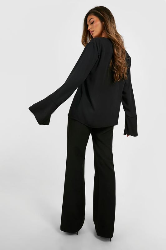 Flared leg design for a dramatic silhouette
        High-waisted fit accentuates the waistline
        Tailored construction for a polished look
        Stretchy bi-stretch fabric for comfort and movement
        Versatile style suitable for various occasions
    
    Make a statement with these eye-catching fit & flare tailored trousers from Boohoo. Perfect for the fashion-forward woman who loves to stand out, these trousers combine sophistication with a touch of drama. The high-waisted design elongates your legs, while the flared silhouette adds a bold, retro-inspired flair to your ensemble. Pair them with a cropped blazer and pointed-toe heels for a chic night out look, or dress them down with a fitted turtleneck and ankle boots for a stylish daytime outfit. The bi-stretch fabric ensures all-day comfort, allowing you to move with ease whether you're dancing the night away or navigating a busy day in the city. These trousers are a versatile addition to your wardrobe, easily transitioning from office to evening drinks with a simple change of accessories.