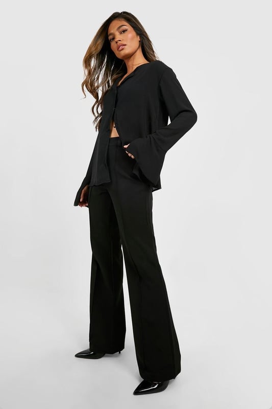 Flared leg design for a dramatic silhouette
        High-waisted fit accentuates the waistline
        Tailored construction for a polished look
        Stretchy bi-stretch fabric for comfort and movement
        Versatile style suitable for various occasions
    
    Make a statement with these eye-catching fit & flare tailored trousers from Boohoo. Perfect for the fashion-forward woman who loves to stand out, these trousers combine sophistication with a touch of drama. The high-waisted design elongates your legs, while the flared silhouette adds a bold, retro-inspired flair to your ensemble. Pair them with a cropped blazer and pointed-toe heels for a chic night out look, or dress them down with a fitted turtleneck and ankle boots for a stylish daytime outfit. The bi-stretch fabric ensures all-day comfort, allowing you to move with ease whether you're dancing the night away or navigating a busy day in the city. These trousers are a versatile addition to your wardrobe, easily transitioning from office to evening drinks with a simple change of accessories.