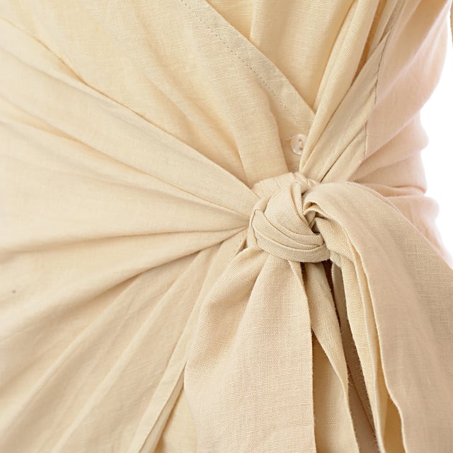 Lining: 100% Cotton, Main: 55% Cotton, Main: 45% Linen. The Pretty Lavish collared wrap mini dress in sand is a versatile piece that exudes a relaxed elegance.