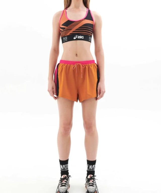 92% Recycled Polyester &amp; 8% Elastane. Running short made with lightweight recycled spray fabrication. Encased elastic waistband with an internal mesh brief. 2X zip pockets on side along with a P.E Nation printed logo