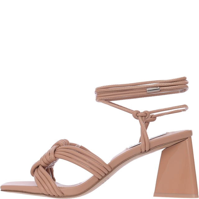 Upper: 100% Polyurethane, Lining: 100% Polyurethane, Sole: 100% Rubber. The Steve Madden Miraya ankle tie heeled sandals in tan are a stunning addition to any wardrobe, featuring a playful design on the front that adds a touch of whimsy to the sophisticated silhouette. These sandals boast a chic lace-up fastening that gracefully wraps around the ankle, a stylish peep toe, and a comfortable mid-block heel perfect for any occasion. Whether paired with a summer dress or your favorite jeans, they promise to elevate your look with their unique charm and elegant construction.