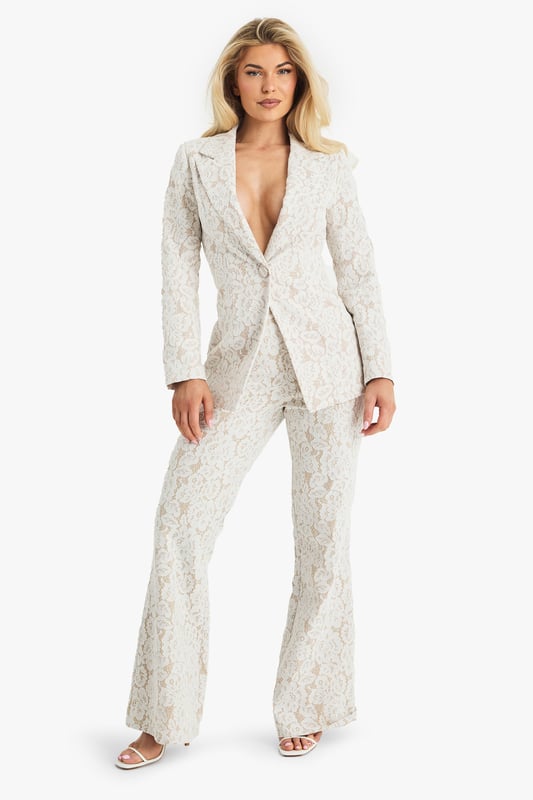 Exquisite lace detailing for a luxurious look
        Slim fit design for a sleek silhouette
        Single-button closure for a polished finish
        Collared neckline adds a touch of sophistication
        Versatile piece suitable for various formal occasions
    
    Make a lasting impression with this stunning lace blazer from Boohoo. Perfect for the fashion-forward woman who desires to stand out at any formal event. The intricate lace pattern adds a touch of romance and elegance, while the slim fit accentuates your figure beautifully. Style it with matching trousers for a coordinated suit look, or pair it with a sleek midi dress for a chic ensemble. Ideal for weddings, races, or graduations, this blazer offers endless styling possibilities. For a more relaxed yet refined look, team it with tailored trousers and a silk camisole. Add some delicate jewellery and strappy heels to complete your outfit. This versatile piece will quickly become a go-to in your wardrobe for those moments when you want to radiate confidence and sophistication.
